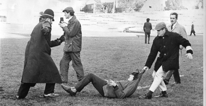 Stewards dragging a protester off the pitch at the Springboks v Swansea rugby match